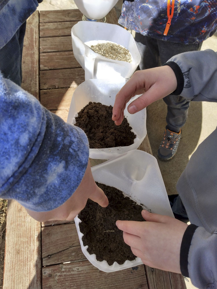 Kids examining healthy soil during a class